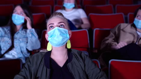 moviegoers wearing masks in theater