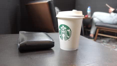 starbucks coffee and wallet on a table