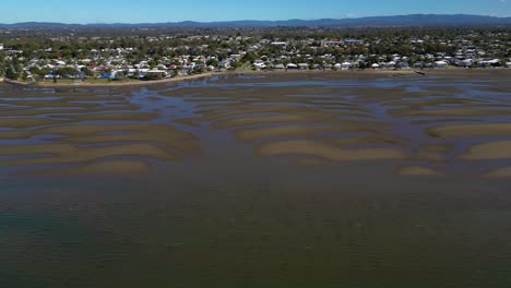 Aerial-view,-left-to-right-of-Sandgate-and-Brighton-waterfront-at-low-tide-on-a-sunny-day,-Brisbane,-Queensland,-Australia