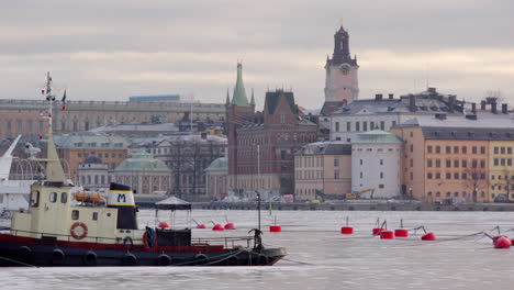 View-towards-Gamla-Stan-over-iced-lake-from-Norr-Mälarstrand,-Stockholm,-Sweden