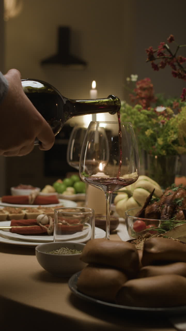 Pouring Wine at a Festive Dinner Table