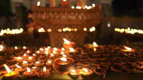 burning candle on wooden table for background.