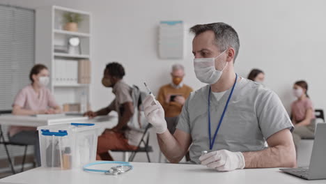 doctor filling syringe with vaccine