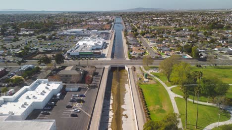 drone-time-lapse-captures-a-water-channel-as-it-winds-its-way-under-overpasses-towards-the-Pacific-Ocean