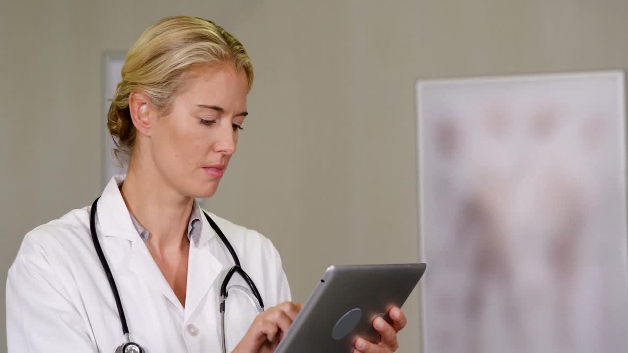 Female physiotherapist using digital tablet