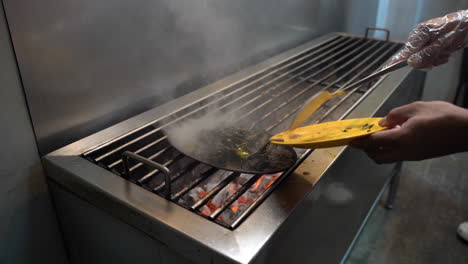 chef preparing sizzling vegetables on charcoal griller. closeup