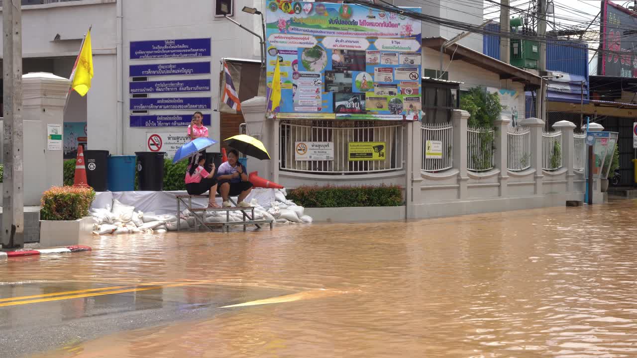 A panoramic view captures the flooded street along Chiang Mai-Lamphun Road, Wat Ket, Mueang Chiang Mai District. This scene highlights the severe flooding during the rainy season in September 2024