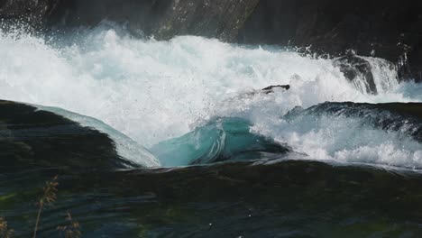 immersive shot: slow-motion close-up of swirling, crashing water