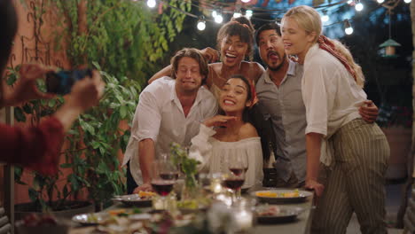 funny group of friends posing for photo at dinner party celebrating friendship enjoying reunion gathering making memories on summer evening outdoors