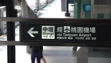 signboard displaying direction of train to zhongli via taoyuan airport taiwan at new taipei industrial park station