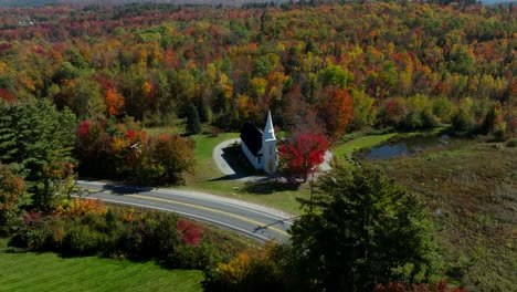 imágenes de drones de una iglesia en new hampshire rodeada de árboles de colores de otoño