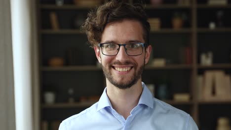 motivated millennial male student worker look at camera with smile