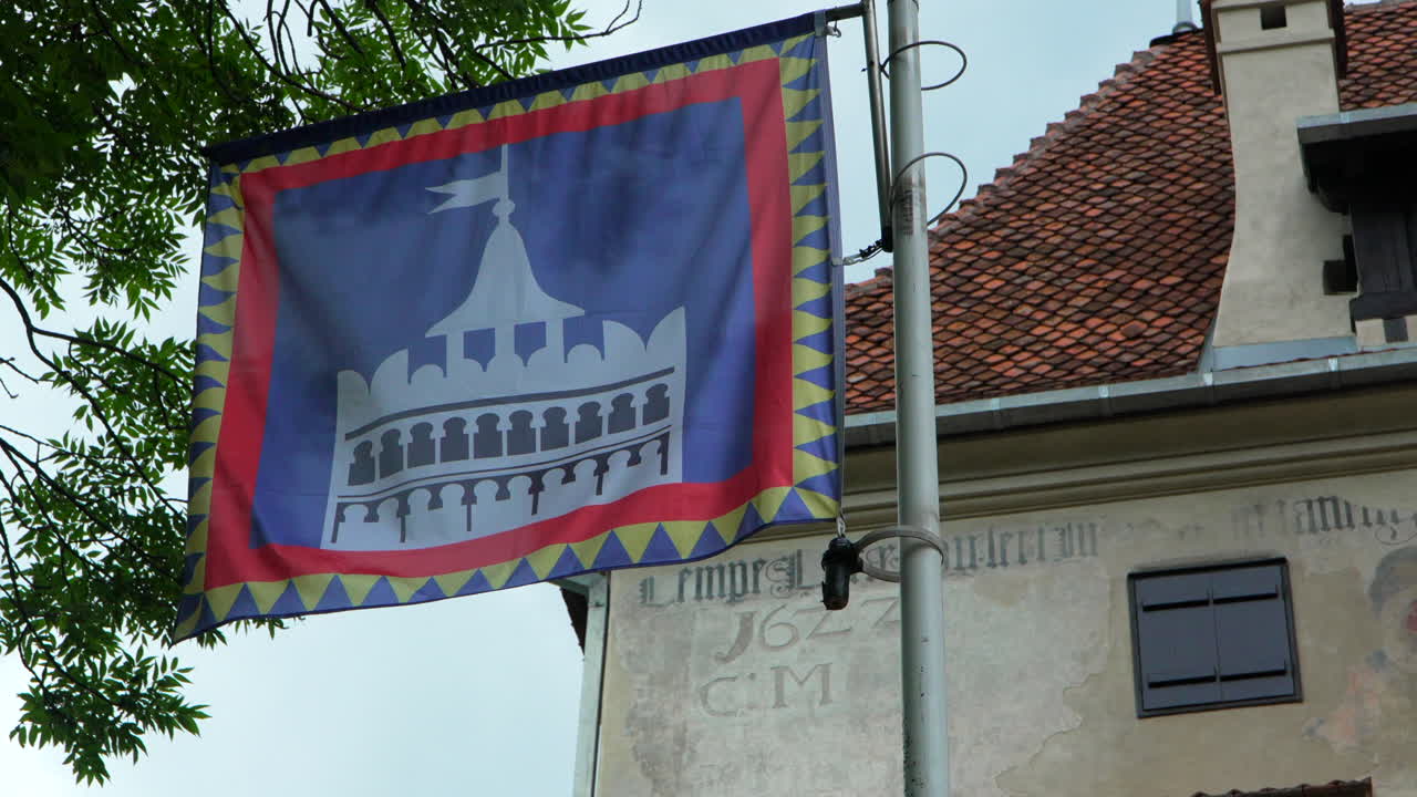 Flag of a fortress waving at Castle of Bran, Romania. Slow motion
