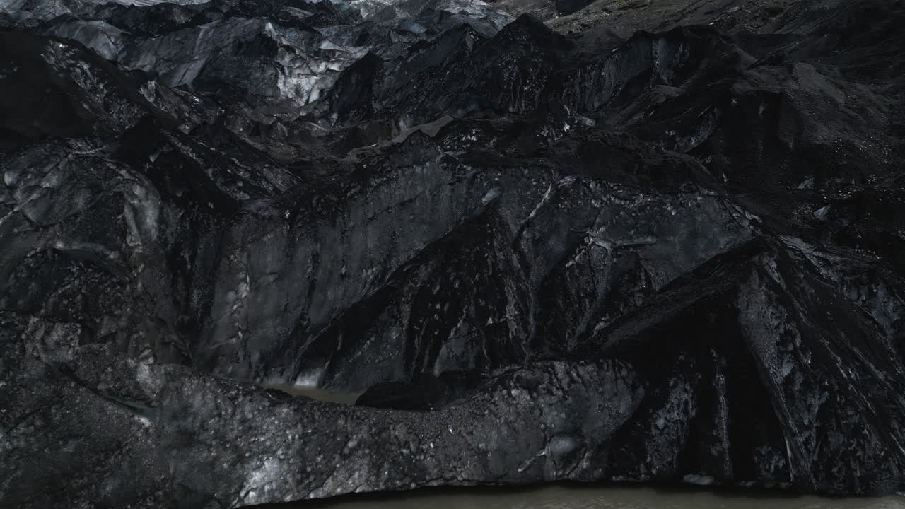 Tourist waves from an island at Iceland's Sólheimajökull glacier
