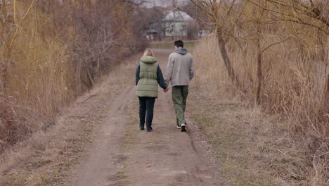 couple walking on a path in autumn