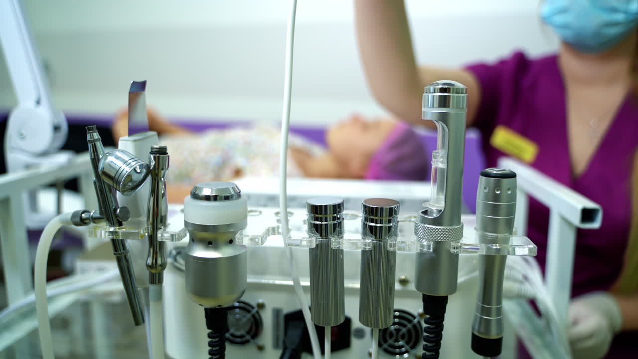 Ultrasonic scrabbing. Ultrasound cavitation facial peeling. Cosmetology facial skin care treatment cleaning. Beautician hands at work.