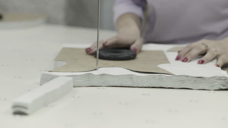 woman cutting fabric patterns