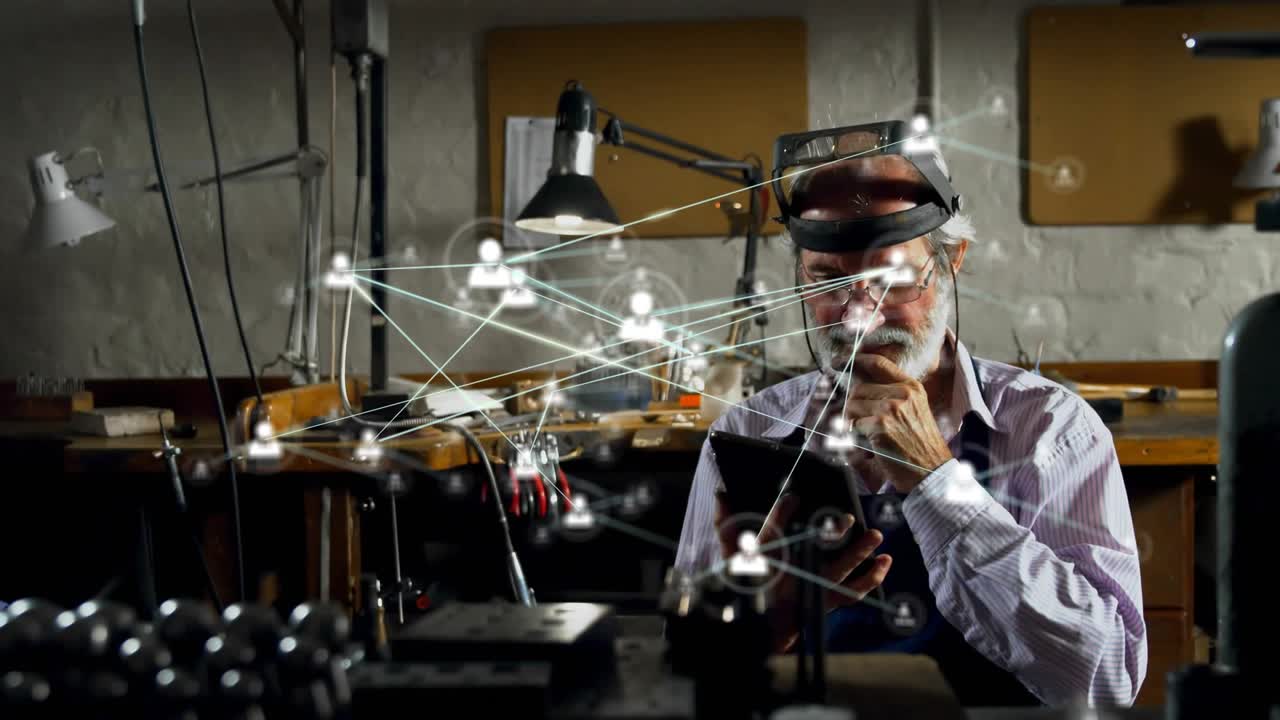 Senior man tapping tablet, initiating animated network icons filling workshop for tech analysis