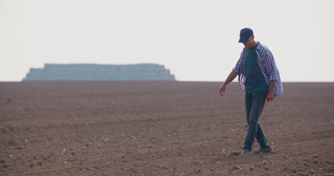 Hands-Examining-Soil-In-Agricultural-Field-9