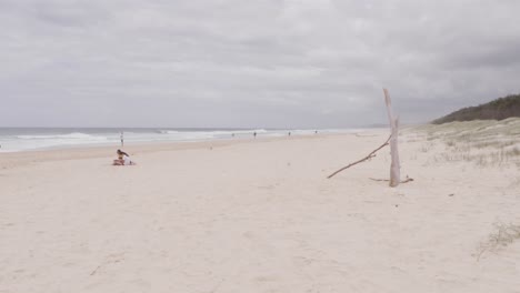 Few-People-At-The-Sandy-Seashore-Of-South-Gorge-Beach-In-Point-Lookout,-North-Stradbroke-Island,-QLD-Australia