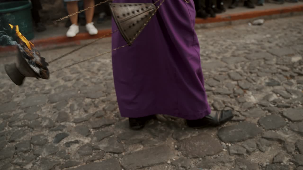 devoto balanceándose mientras camina por la calle durante la procesión en antigua, guatemala