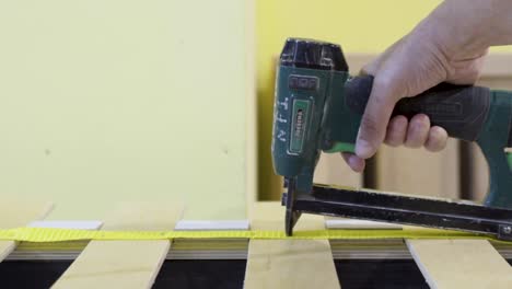 assembling a bed frame with a nail gun