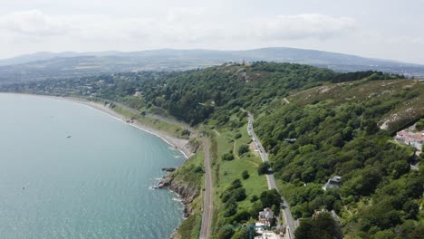 Moving-towards-The-Obelisk-located-in-Killiney-Hill-with-the-view-of-The-Pyramid-of-Dublin-on-a-sunny-day,-Ireland