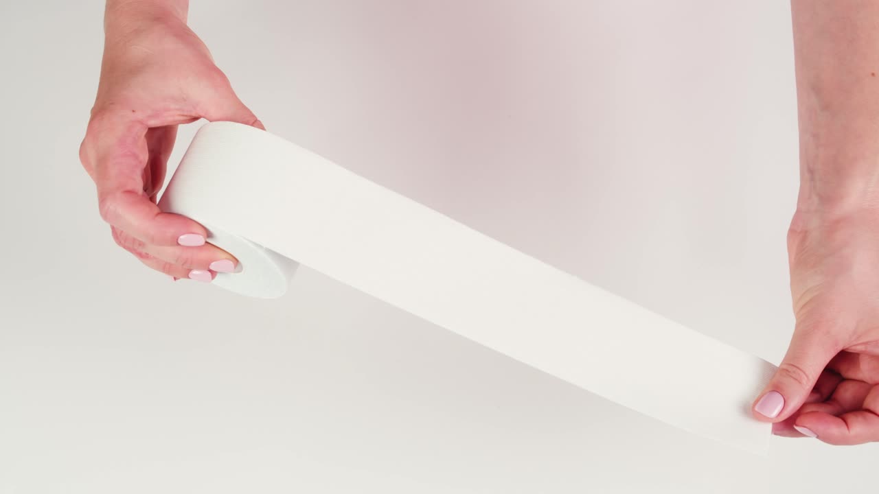 Kinesiology medical taping, doctor Physical therapist applying elastic surgical tape to patient body, treating injured knee young athlete.Post traumatic rehabilitation, sport physical therapy recovery