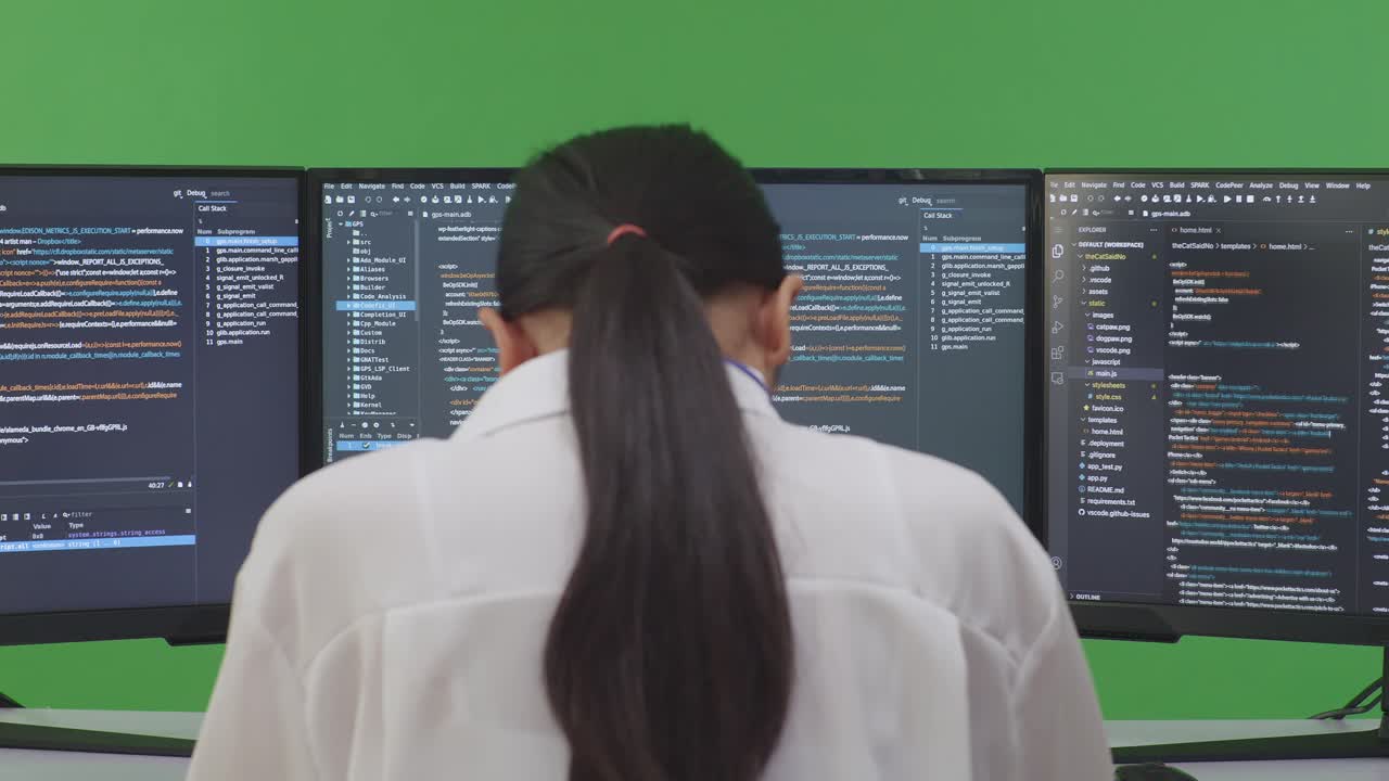 Woman Programmer Coding on Multiple Monitors