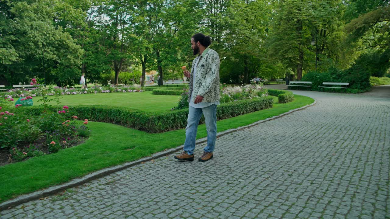 Man Enjoying Ice Cream in a Park