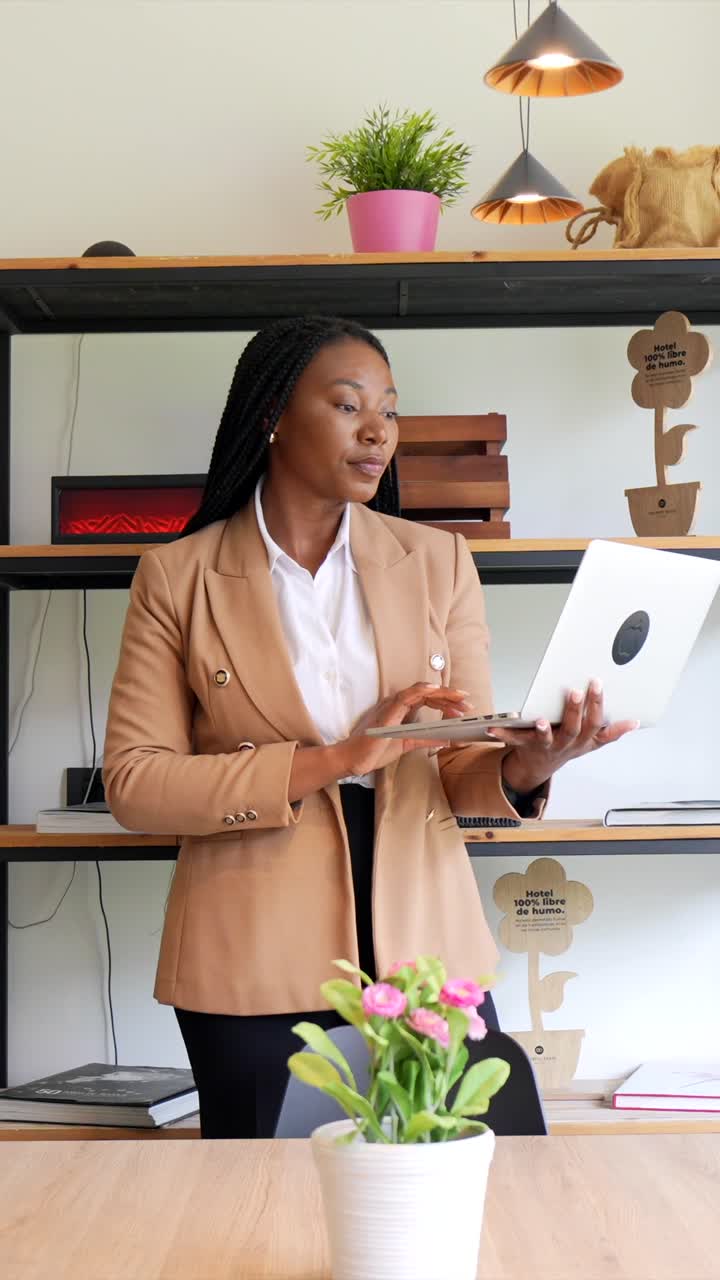 A woman working with a laptop in an office