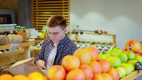 man shopping for fruit at a grocery store