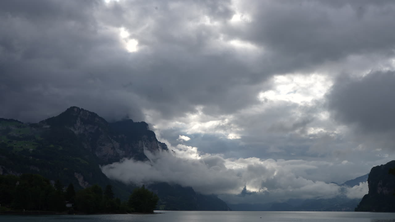 Establishing Shot of Cloudy Sky Over Majestic Mountains and Serene Lake Landscape