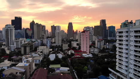 Aerial-Tracking-Left-View-Of-Bangkok's-Skyscrapers-at-Sunrise