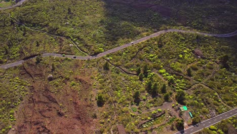 Aerial-view-from-above,-moving-cars-on-serpentine-road-in-Tenerife