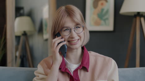 young woman talking on phone at home