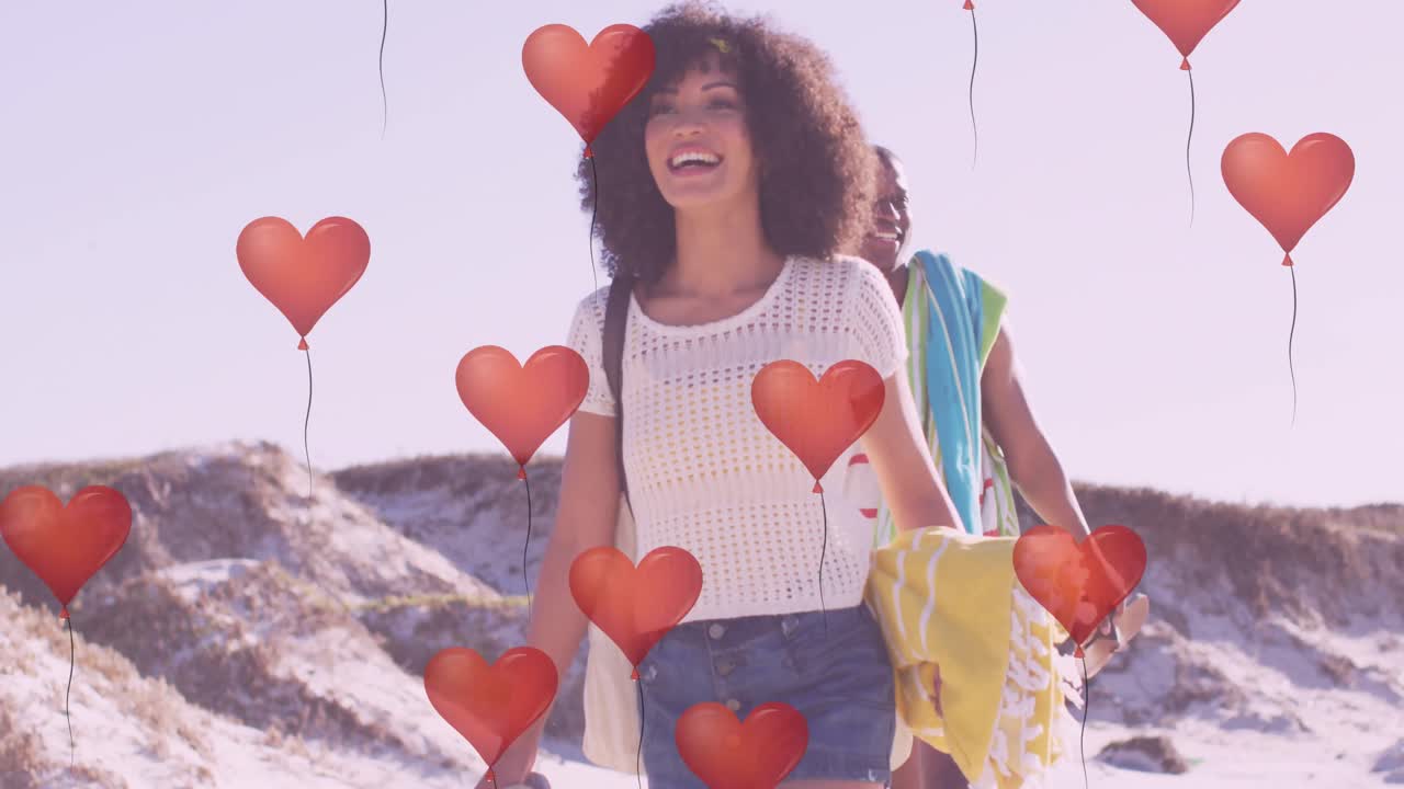 animación de corazones sobre una feliz pareja afroamericana en la playa