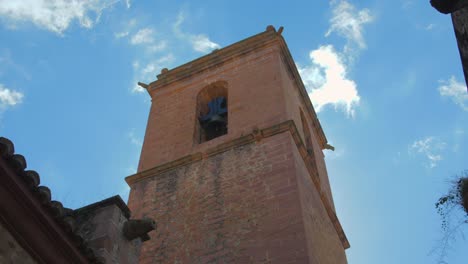 panning across beautiful historic assumption church bell tower of vilafames in castellon, spain