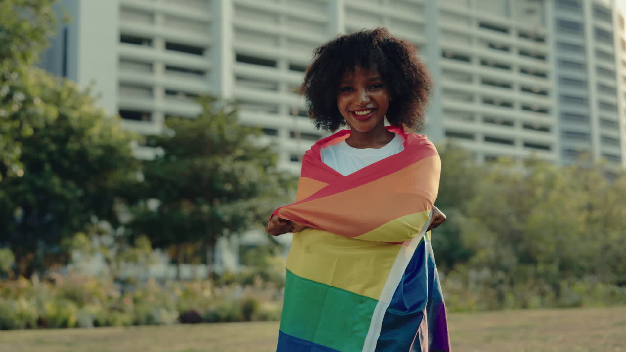 Woman Holding Pride Flag in a Park