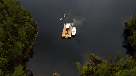 Smoke-rises-from-wood-fired-West-Coast-floating-sauna,-British-Columbia