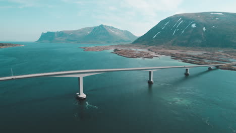 aerial cinematic shots of gimsoystraumen bridge with breathtaking norwegian landscapes