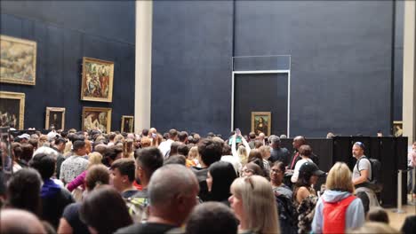tourists visiting mona lisa in louvre museum, france