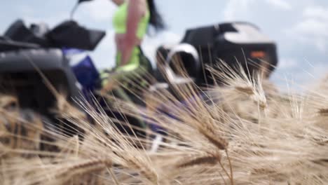 woman on a motorcycle in a wheat field