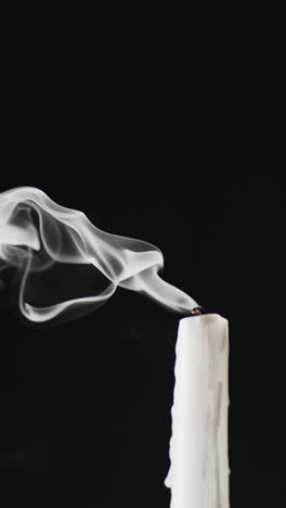 vertical video of extinguished candle and copy space on black background