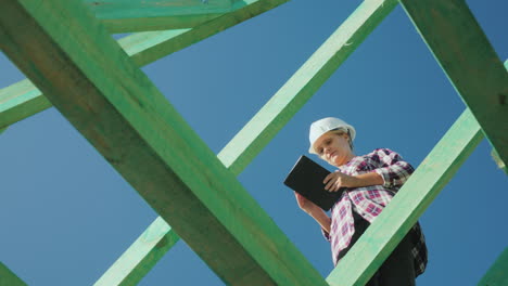 Eine-Architektin-Arbeitet-Mit-Einem-Tablet-Zwischen-Den-Sparren-Der-Dachbauaufsicht