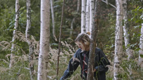 woman using phone in a forest