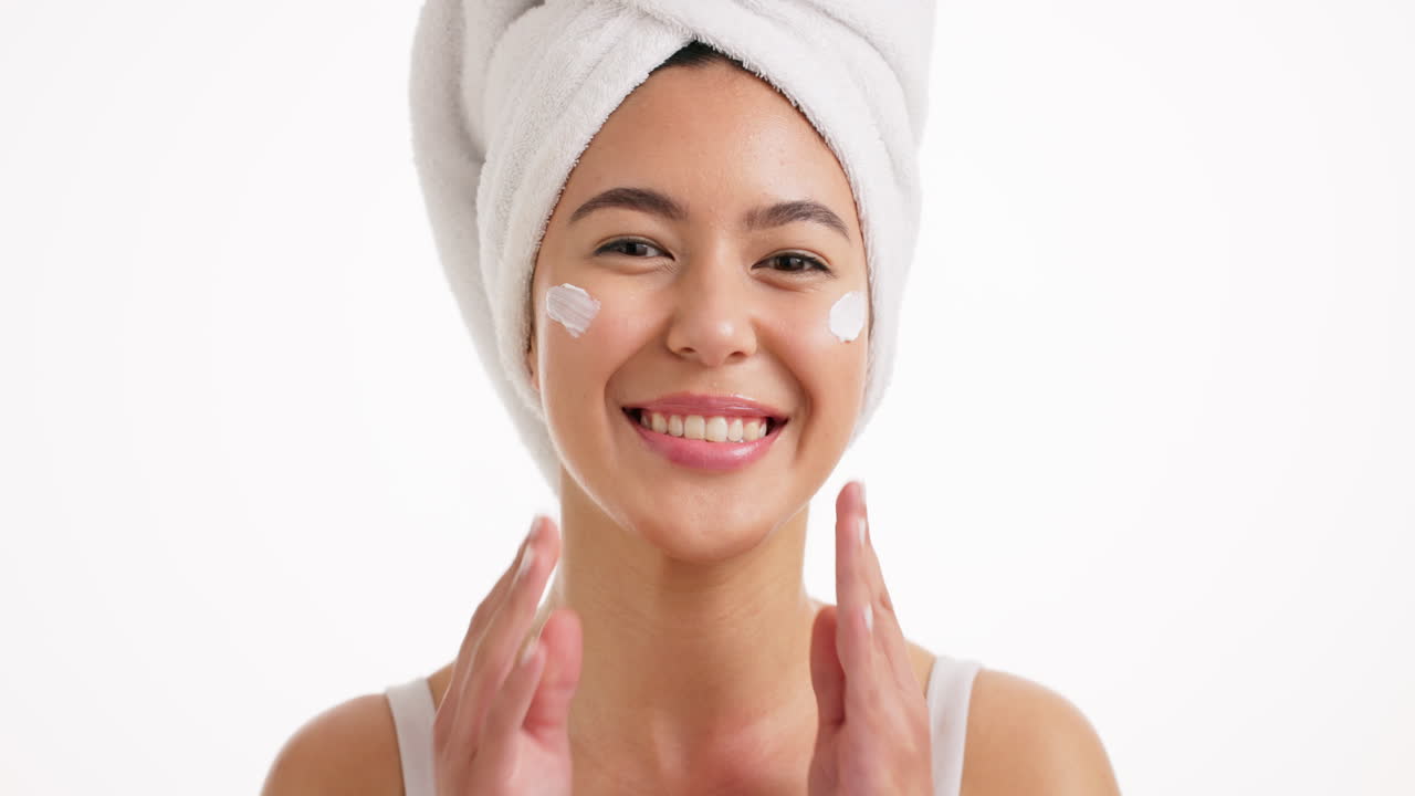 Woman applying skincare cream to her face