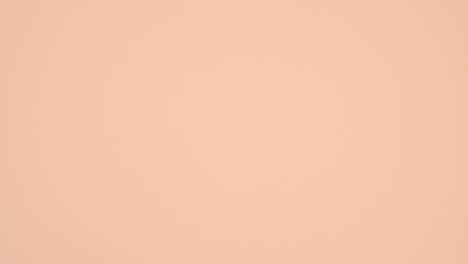 love wooden letters come out from pastel pink gift with ribbon on bright orange theme. stop motion flat lay
