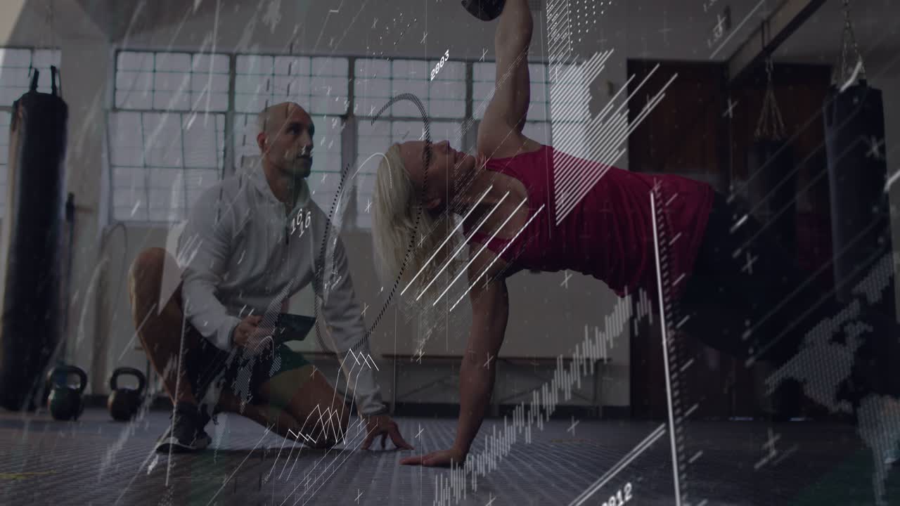 Trainee holding side plank doing kettlebell row or press for fitness coach noting tablet HUD metrics