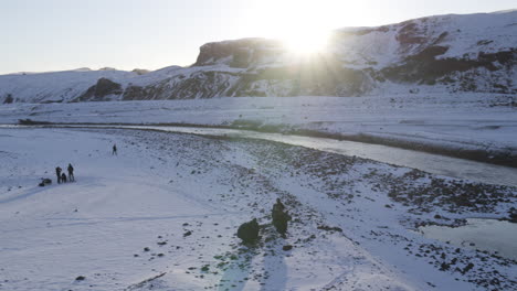 aerial rotating shot of people packing their parachutes in a icelandic valley